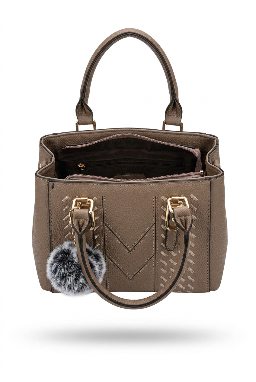 Elevate Your Style with Our Classic Black Top-Handle Handbag in brown with stylish details and a plush pom-pom.