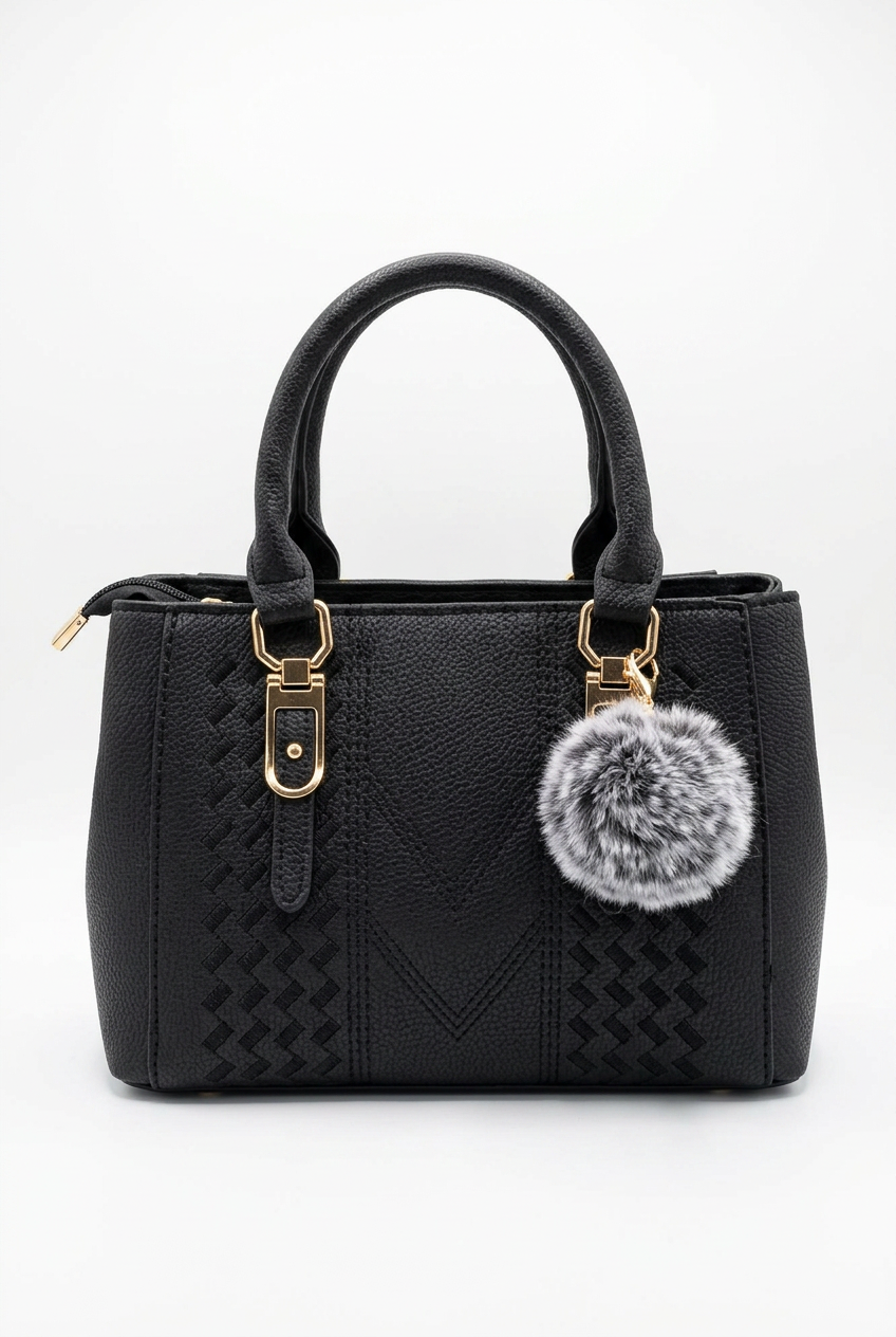 Elevate Your Style with Our Classic Black Top-Handle Handbag featuring a chic plush pom-pom.