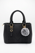 Elevate Your Style with Our Classic Black Top-Handle Handbag featuring a chic plush pom-pom.