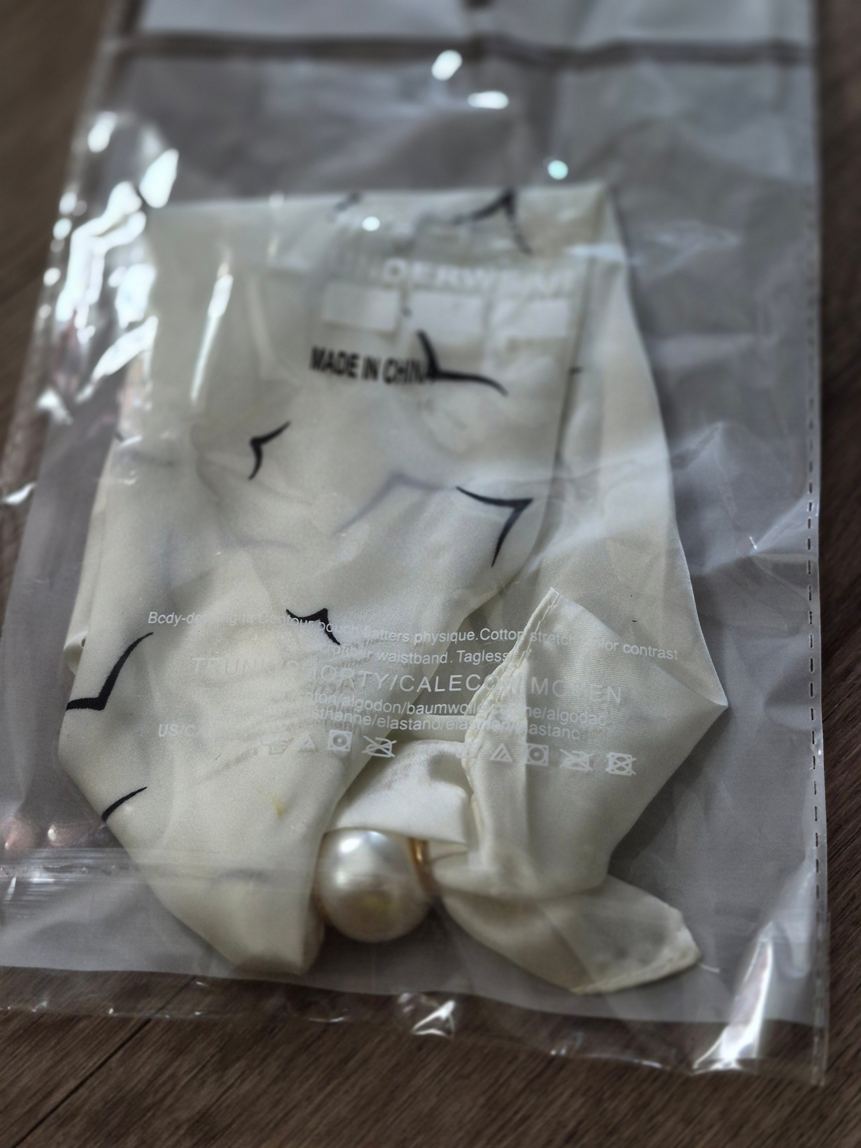 Aria Floral Silk-Feeling Neckerchief Scarf with a Pearl Slide in packaging with pearl detail.