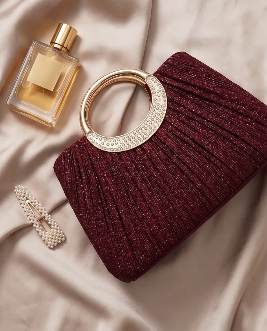 Elegant Burgundy Evening Bag - Seraphina Pleated Satin Top-Handle Purse styled with a perfume and hair accessory.
