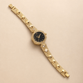Gold-Tone Rhinestone Bracelet Watch | Luxury Jewelry Watch for Women with a bold bracelet and black dial.