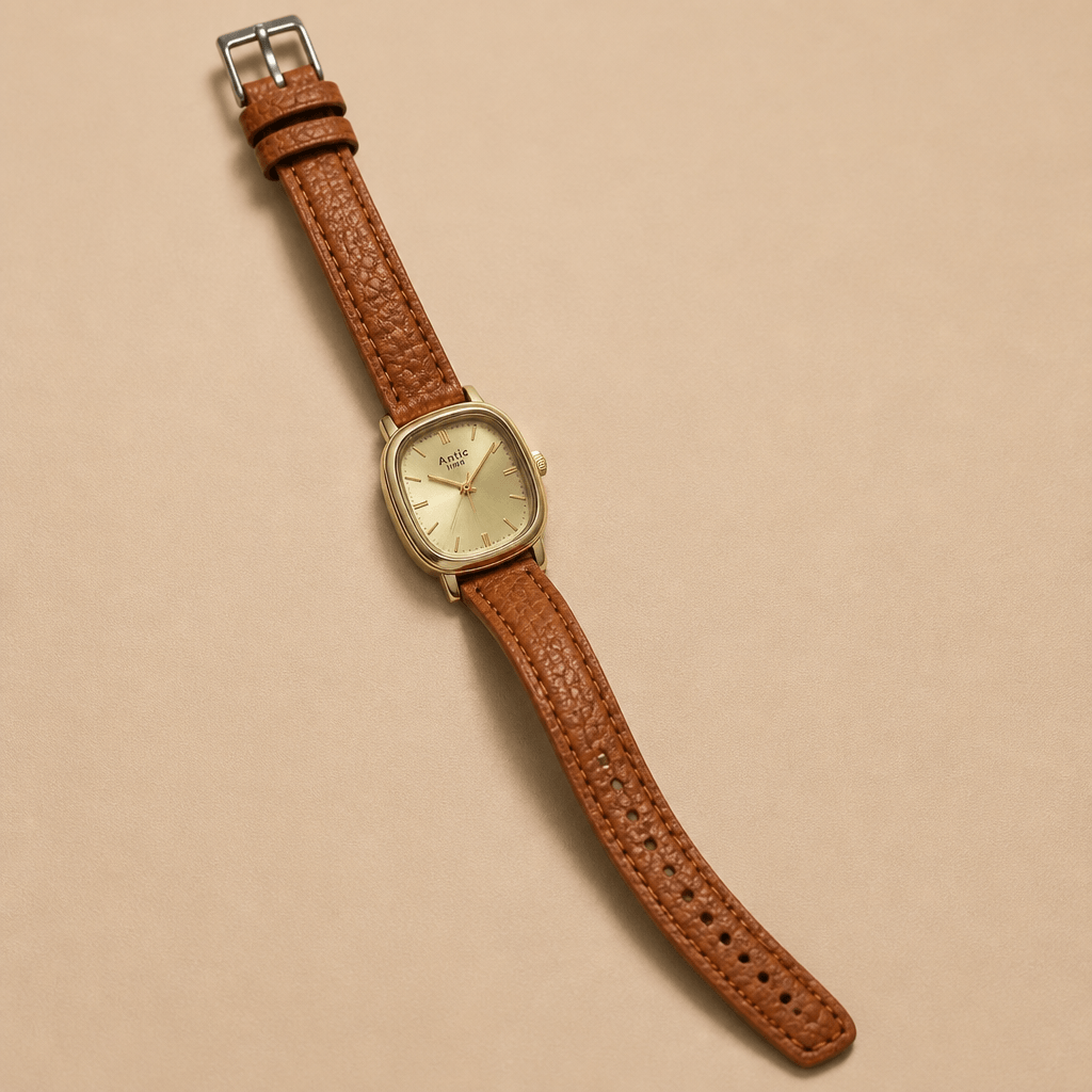Vintage Cushion-Case Women's Watch | Gold-Plated & Emerald Leather Strap on a tan background.