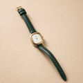 Vintage Cushion-Case Women's Watch | Gold-Plated & Emerald Leather Strap on a light background.