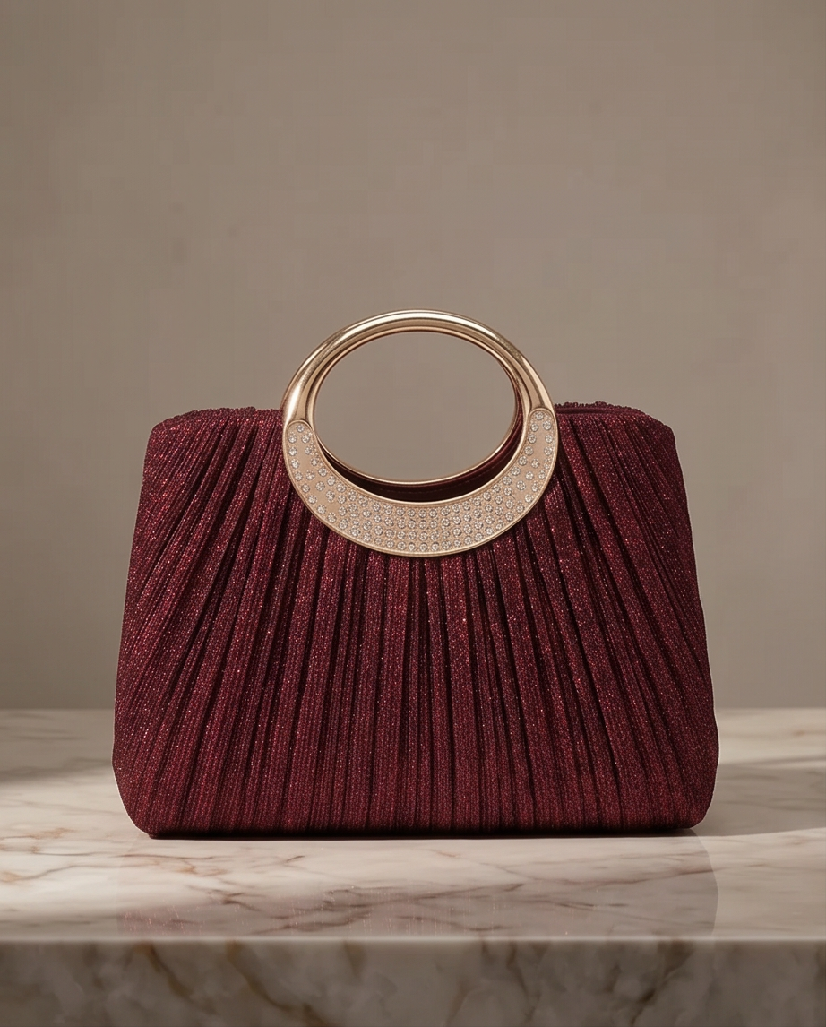 Elegant Burgundy Evening Bag - Seraphina Pleated Satin Top-Handle Purse on a marble surface.