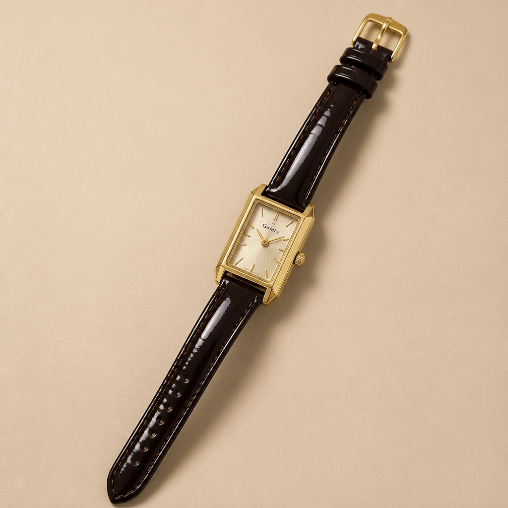 Gaiety Classic Gold Dial Watch | Rectangular Case & Leather Strap on a beige background.